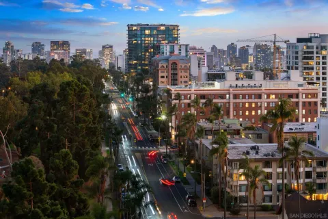 a kitchen with furniture a refrigerator and a stove top oven