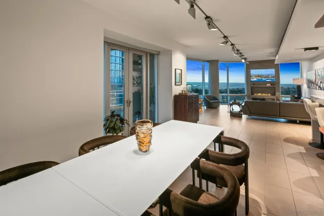 a dining room with wooden floor and furniture