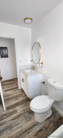 a bathroom with a toilet a sink and a mirror