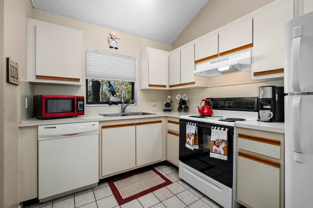 a kitchen with stainless steel appliances granite countertop a stove and cabinets