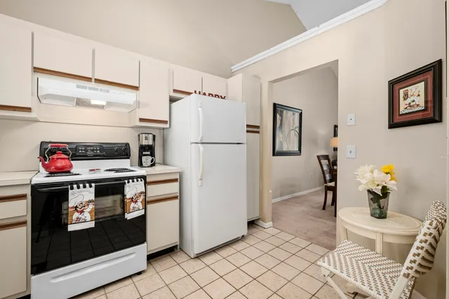 a kitchen with stainless steel appliances a stove a refrigerator and cabinets