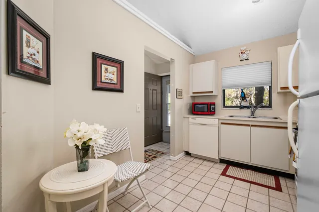 a kitchen that has a sink and a refrigerator in it