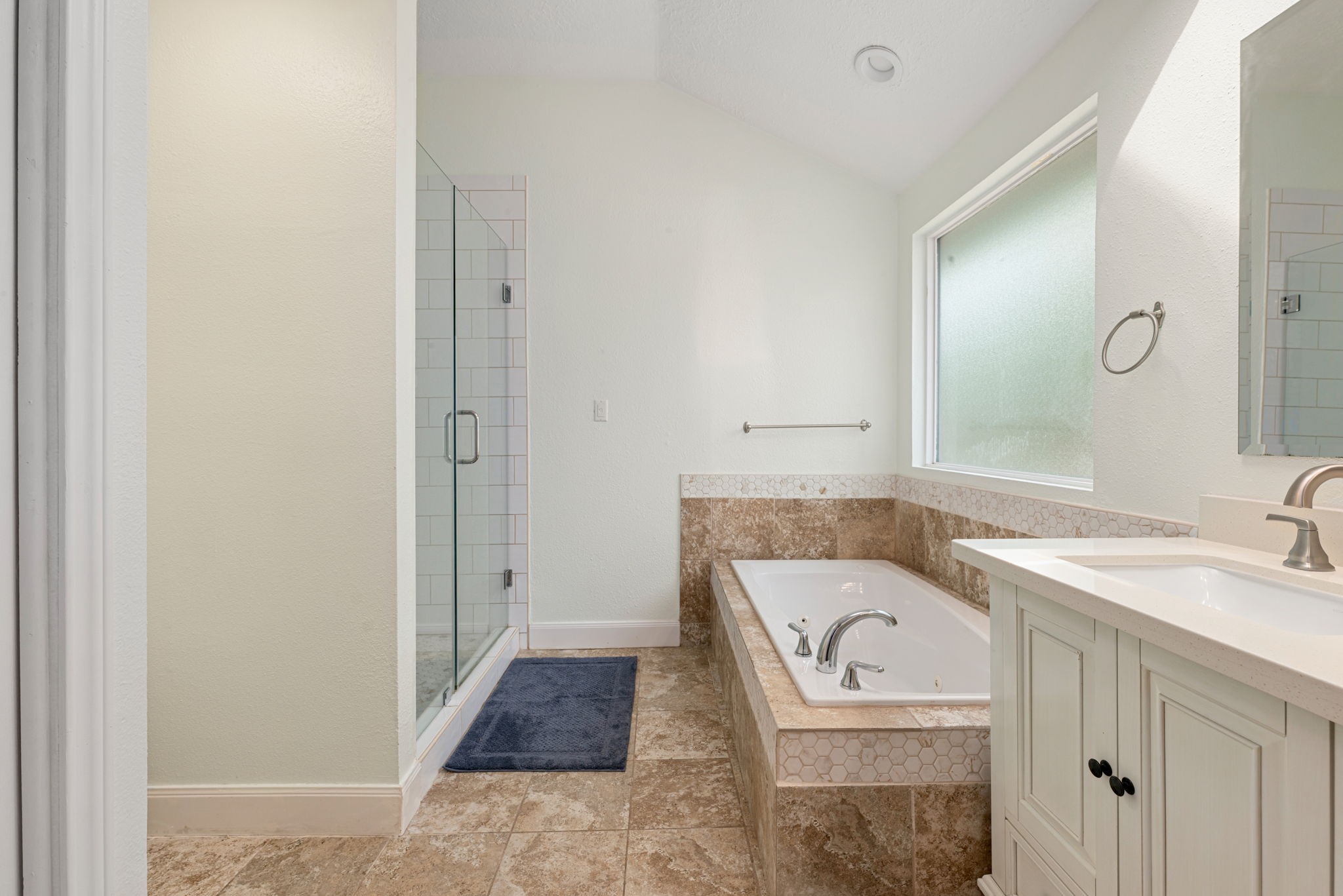 1915 Mercoal Drive Spring, TX 77386 - Photo 19 of 50 Spa-inspired primary bathroom offering a relaxing soaking tub and spacious vanity.