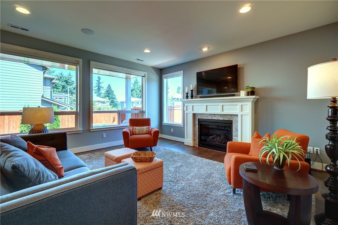 15 175th Place Southwest Bothell, WA 98012 - Photo 7 of 40 a living room with furniture a flat screen tv and a fireplace