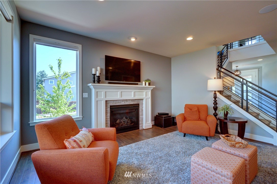 15 175th Place Southwest Bothell, WA 98012 - Photo 8 of 40 a living room with furniture a flat screen tv and a fireplace