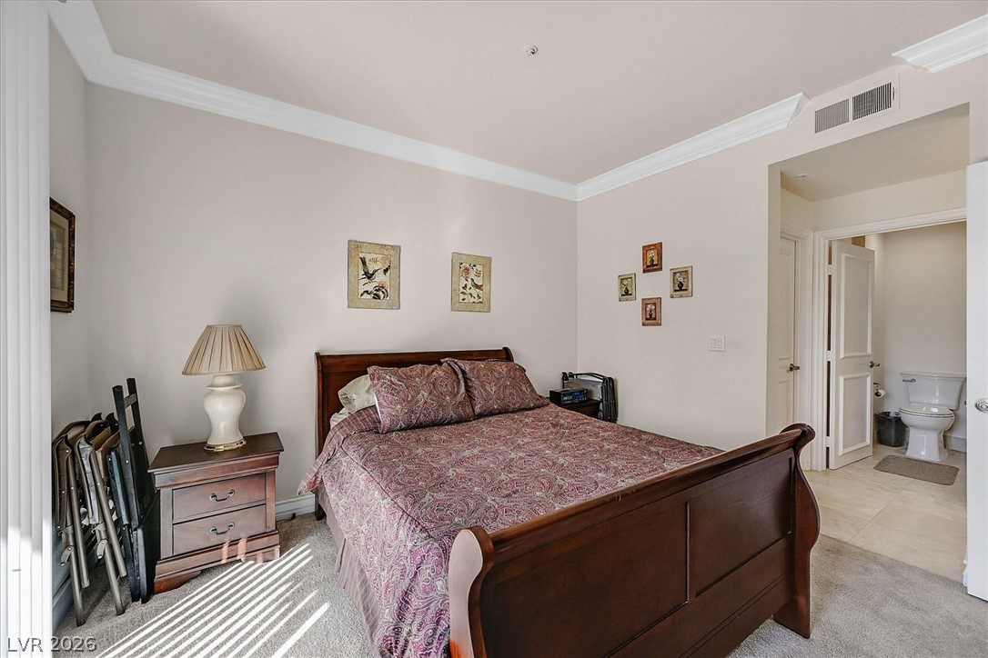220 East Flamingo Road, Unit 305 Las Vegas, NV 89169 - Photo 10 of 26 Relax in this comfortable bedroom featuring plush carpeting and an adjoining tiled bathroom.