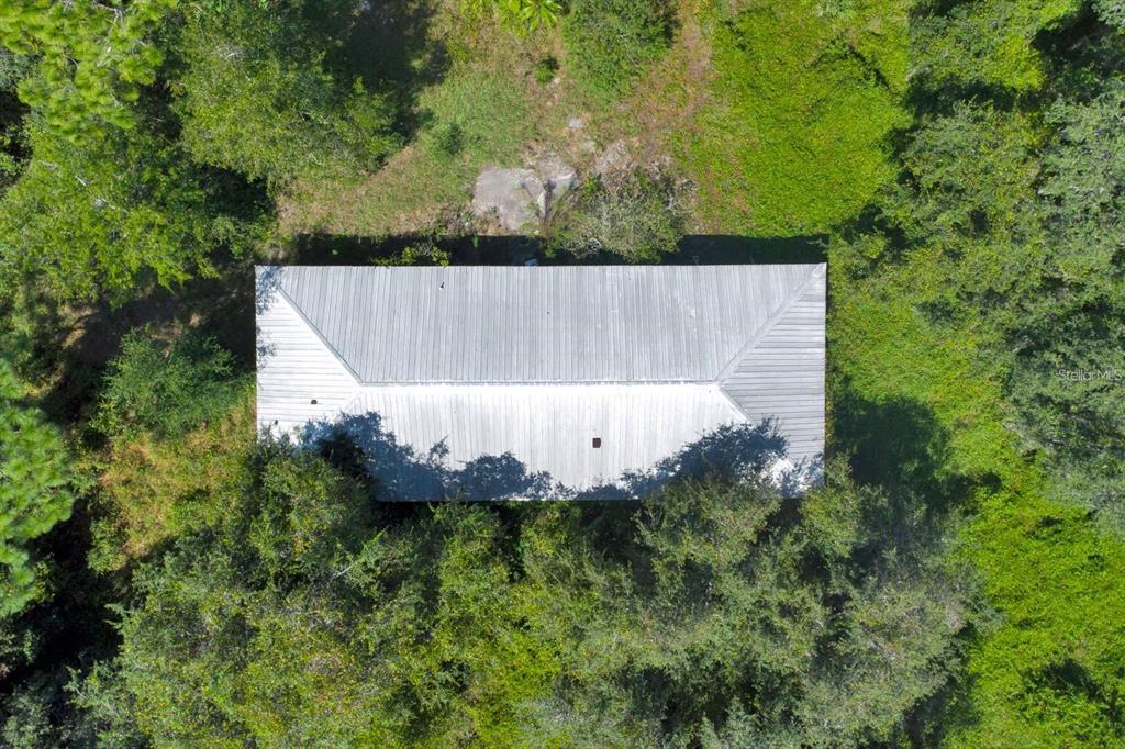 2795 Absher Road St. Cloud, FL 34771 - Photo 12 of 12 an aerial view of a house with a yard and trees all around