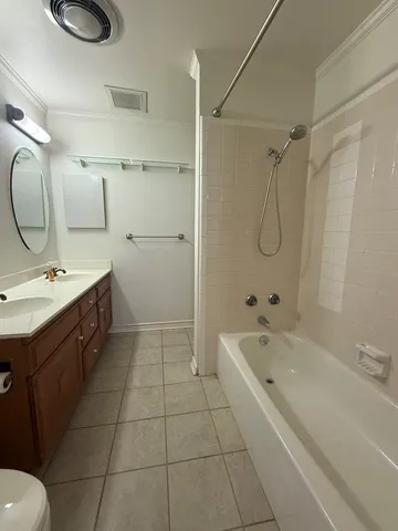 a bathroom with a tub sink and mirror