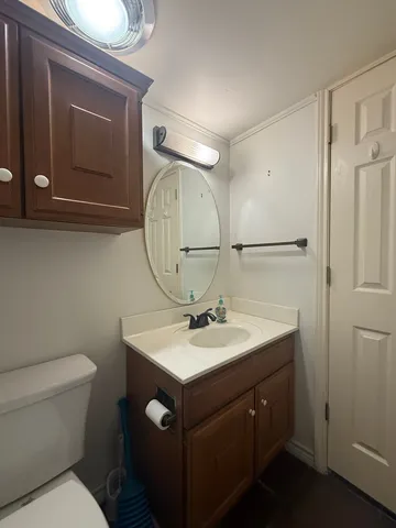 a bathroom with a toilet sink and mirror