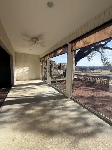 a view of a hallway with wooden floor and a floor to ceiling window