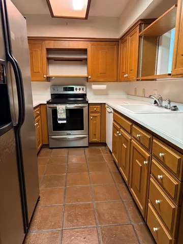 a kitchen with stainless steel appliances a stove a sink and a microwave