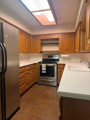 a kitchen with cabinets and steel stainless steel appliances