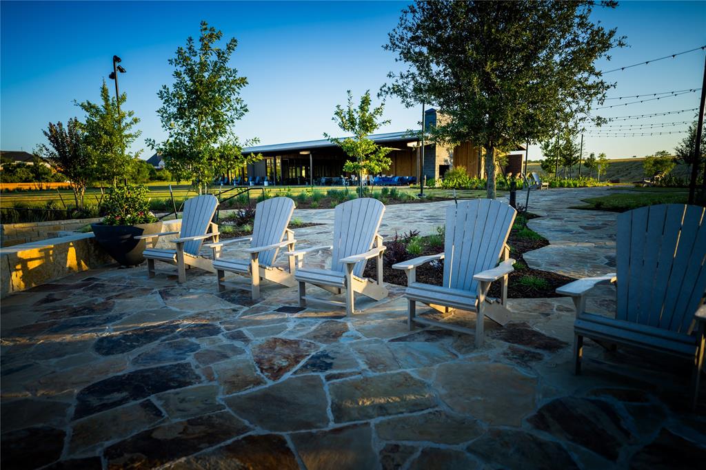 179 Summer Rain Way Rhome, TX 76078 - Photo 24 of 26 a view of a patio with table and chairs and potted plants