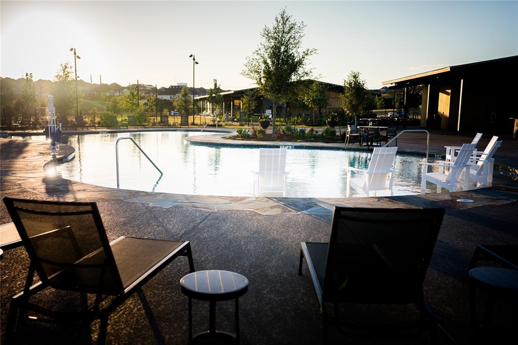179 Summer Rain Way Rhome, TX 76078 - Photo 4 of 26 a kitchen with a table chairs stove and cabinets