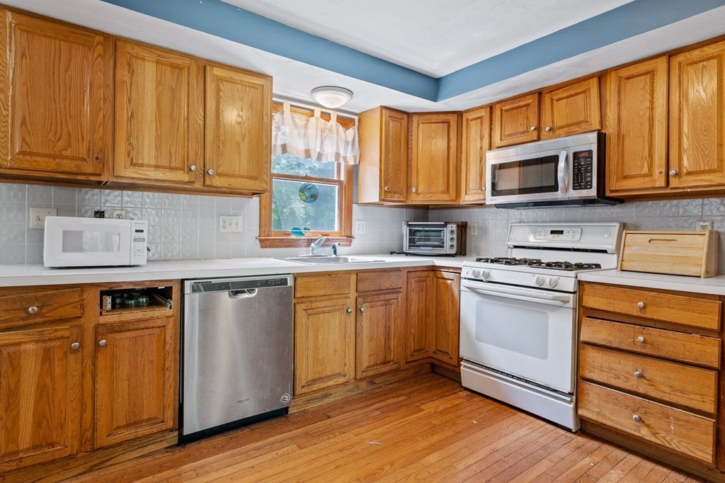 44 Smith Road Mansfield, MA 02048 - Photo 12 of 21 a kitchen with stainless steel appliances granite countertop a stove a sink and a microwave