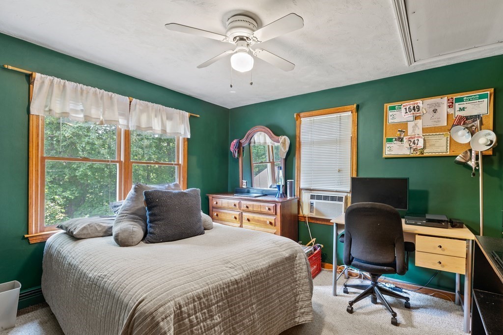 44 Smith Road Mansfield, MA 02048 - Photo 18 of 21 a bedroom with a large bed and a chandelier