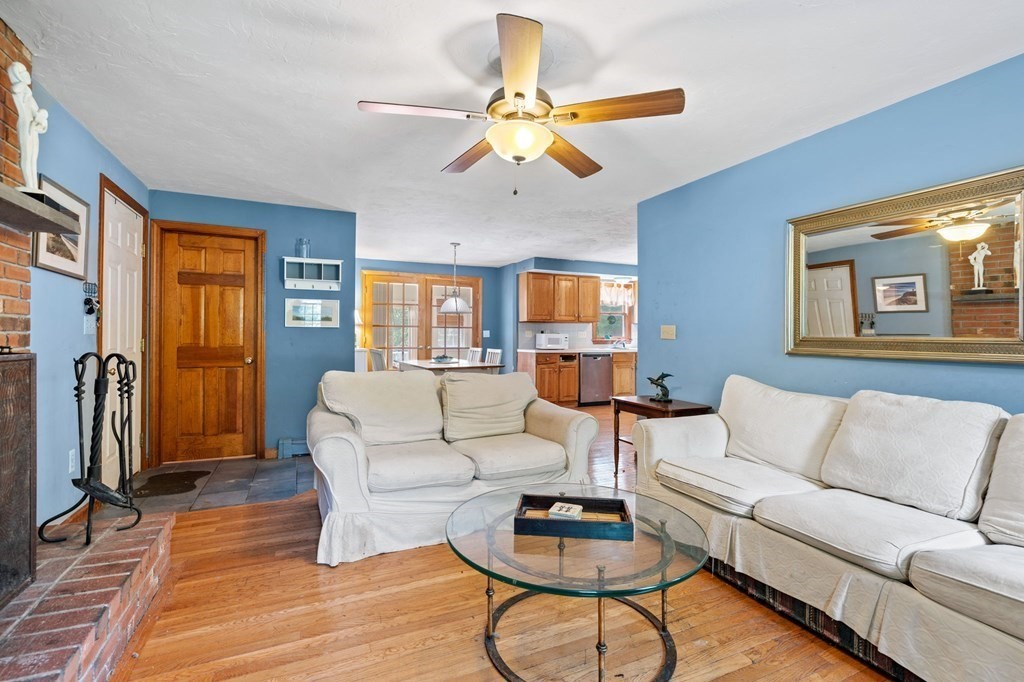 44 Smith Road Mansfield, MA 02048 - Photo 4 of 21 a living room with furniture a large window and a chandelier