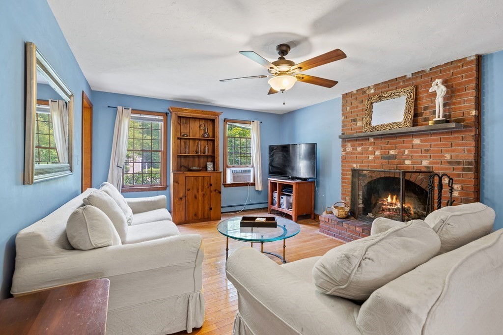 44 Smith Road Mansfield, MA 02048 - Photo 5 of 21 a living room with furniture a fireplace and a flat screen tv