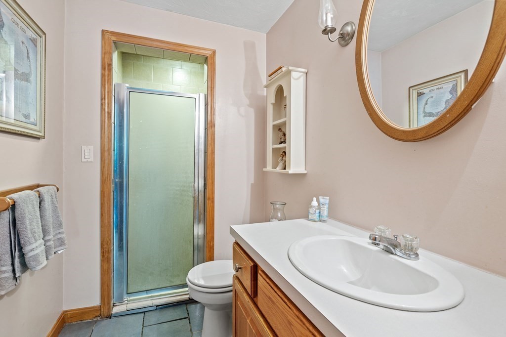 44 Smith Road Mansfield, MA 02048 - Photo 6 of 21 a bathroom with a sink a mirror a toilet and a shower