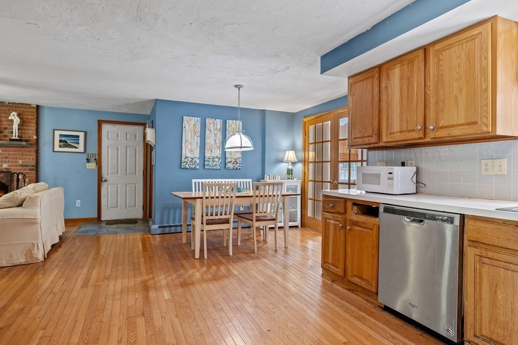 44 Smith Road Mansfield, MA 02048 - Photo 8 of 21 a kitchen with granite countertop wooden floors and wooden cabinets