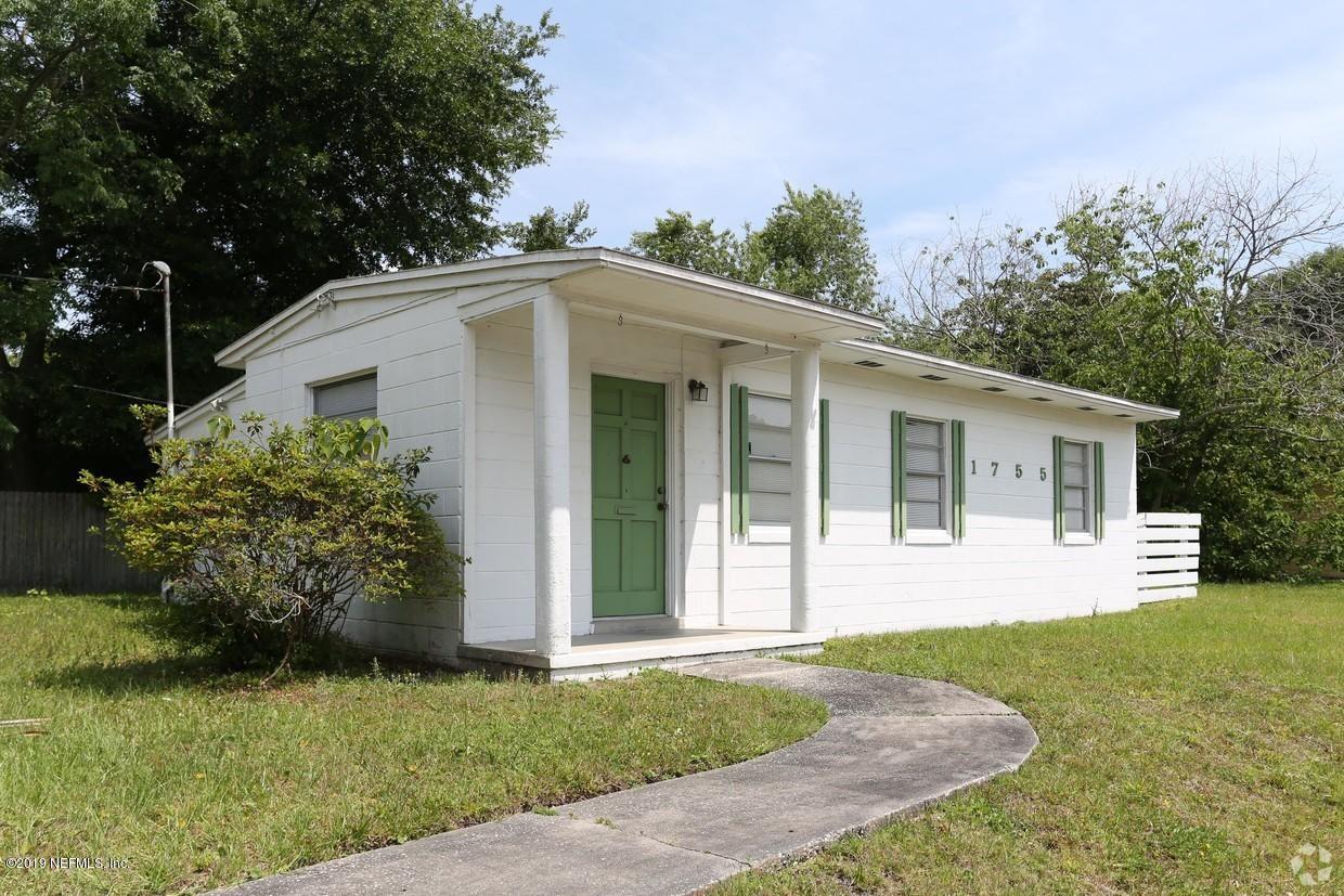 1755 Rogero Road Jacksonville, FL 32211 - Photo 1 of 1 a view of a white house next to a yard with big trees