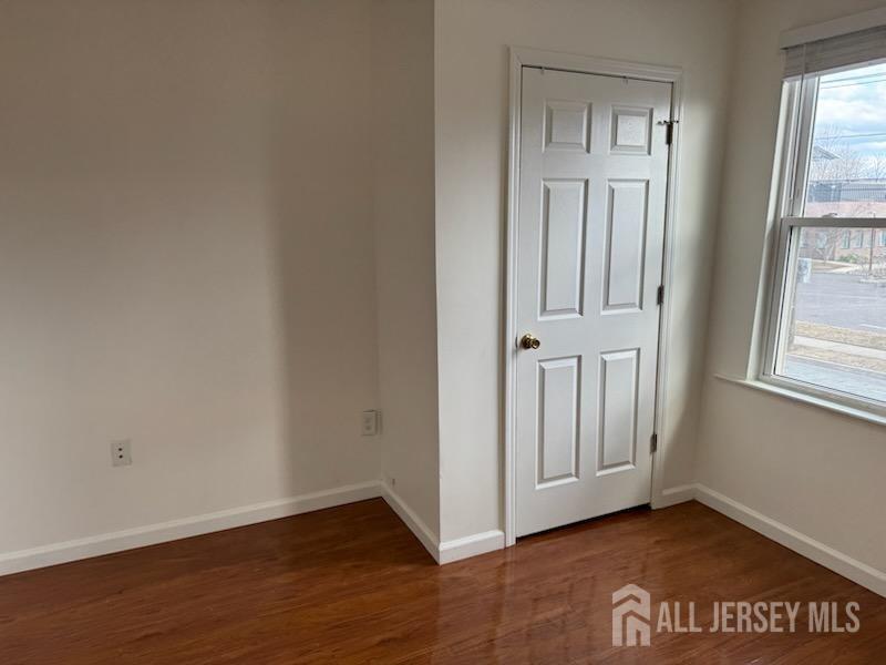 721 Lincoln Boulevard Middlesex, NJ 08846 - Photo 6 of 11 an empty room with wooden floor and windows