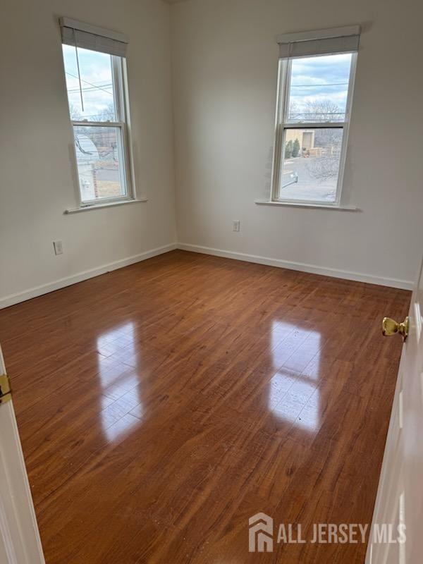 721 Lincoln Boulevard Middlesex, NJ 08846 - Photo 10 of 11 an empty room with wooden floor and windows