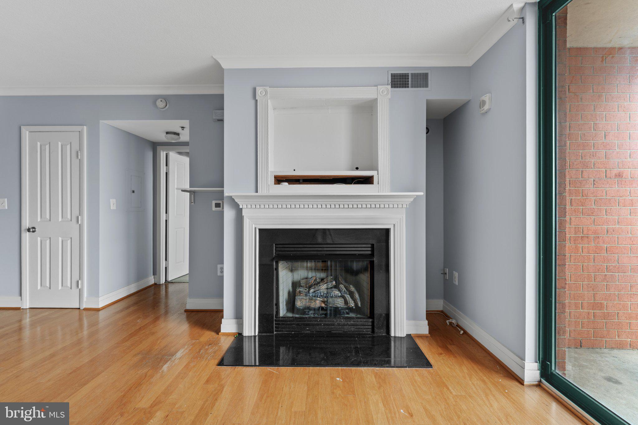 414 Water Street, Unit 1306 Baltimore, MD 21202 - Photo 13 of 29 Cozy living space with elegant fireplace.