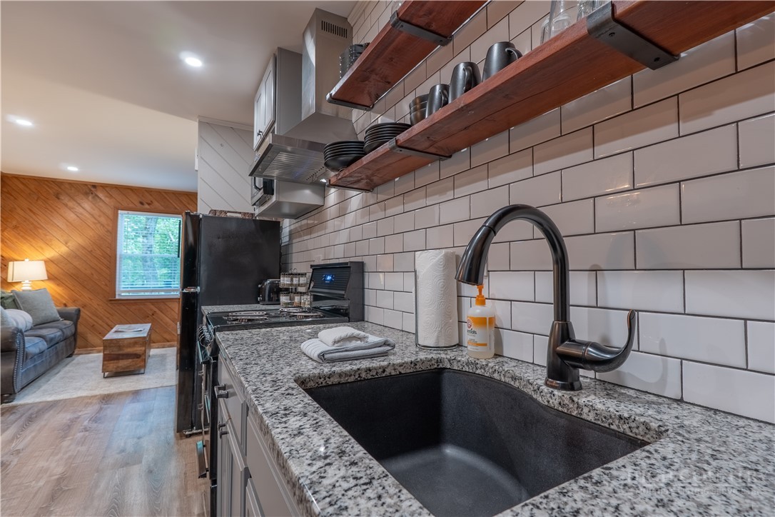 141 Snowflake Road Banner Elk, NC 28604 - Photo 21 of 28 a kitchen with a sink and a stove top oven