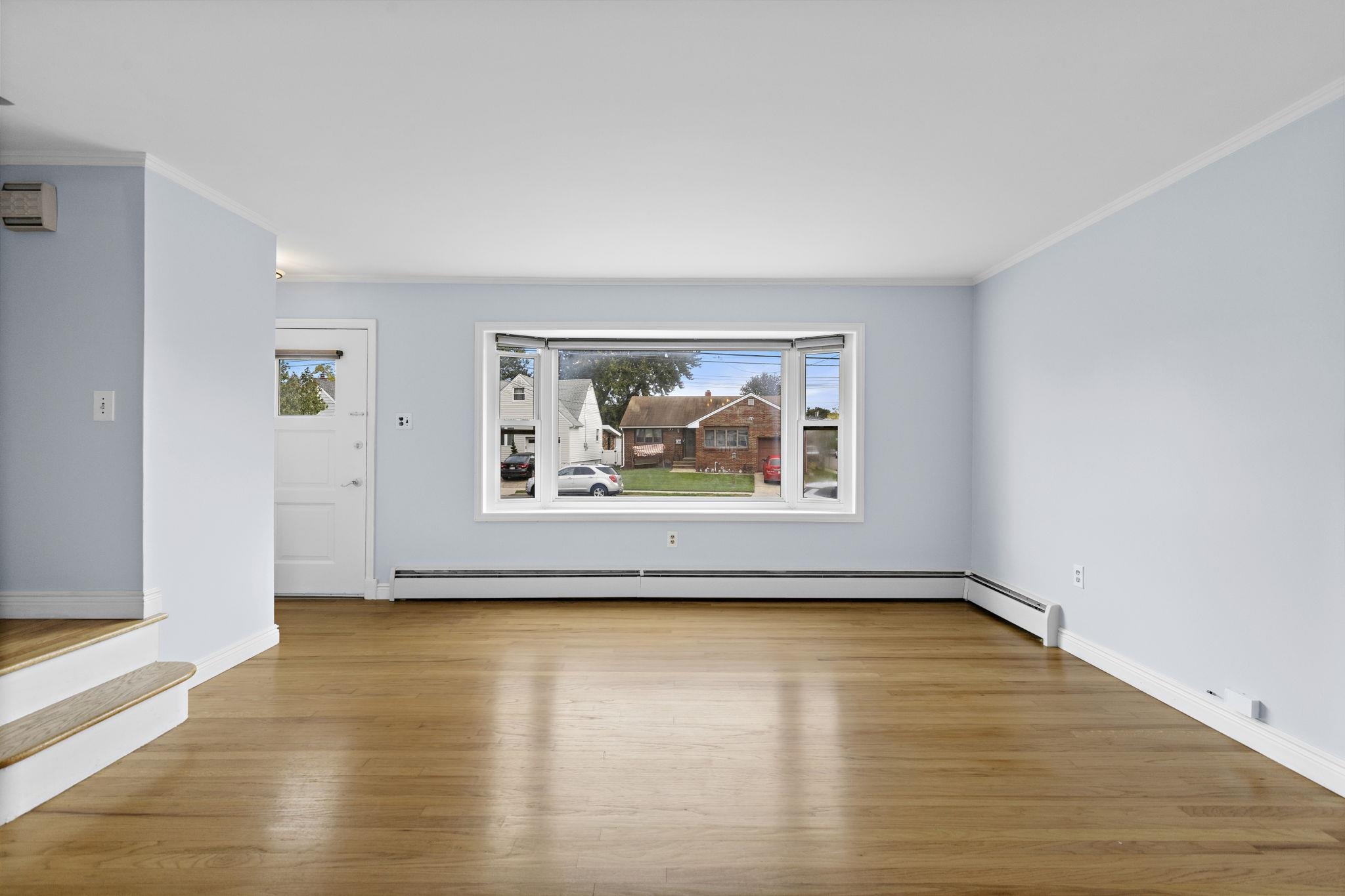 665 9th Street, Unit A Secaucus, NJ 07094 - Photo 3 of 17 a view of a room with wooden floor and window