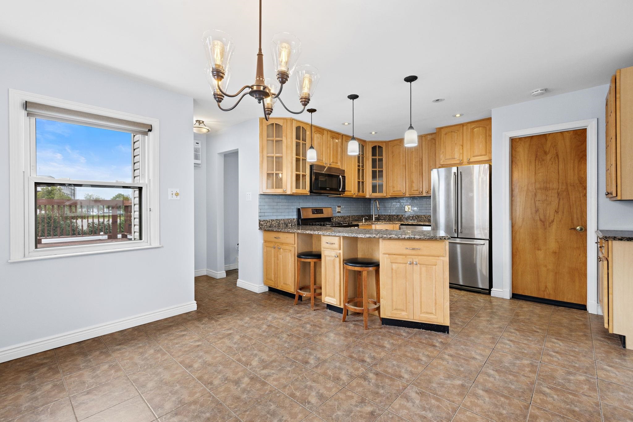 665 9th Street, Unit A Secaucus, NJ 07094 - Photo 8 of 17 a kitchen with white cabinets and stainless steel appliances