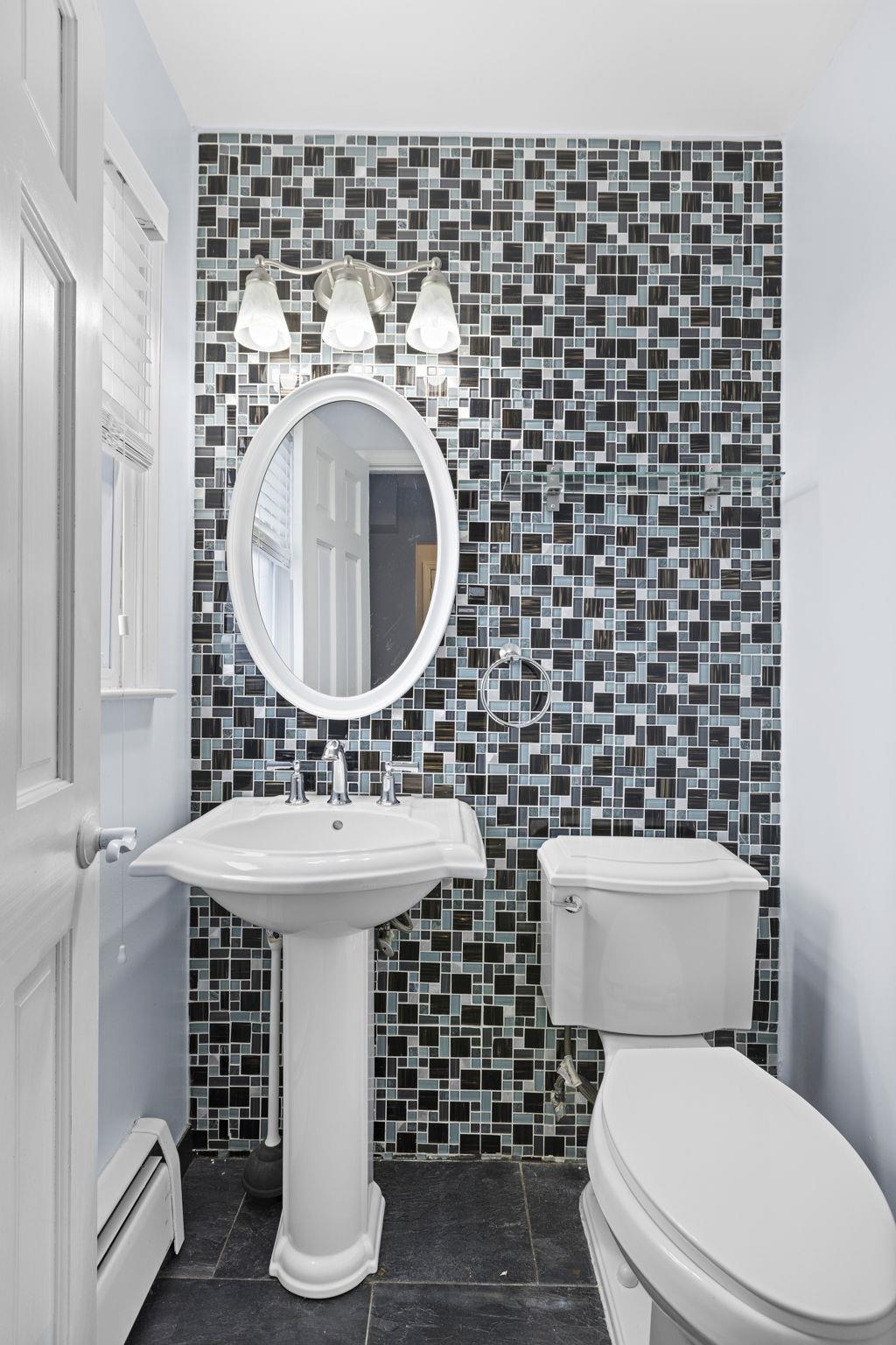 665 9th Street, Unit A Secaucus, NJ 07094 - Photo 9 of 17 a bathroom with a sink toilet and a mirror