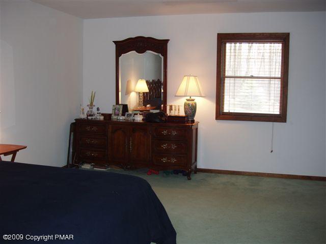 153 Little Twig Road Effort, PA 18330 - Photo 10 of 22 a bed room with a bed and a dresser