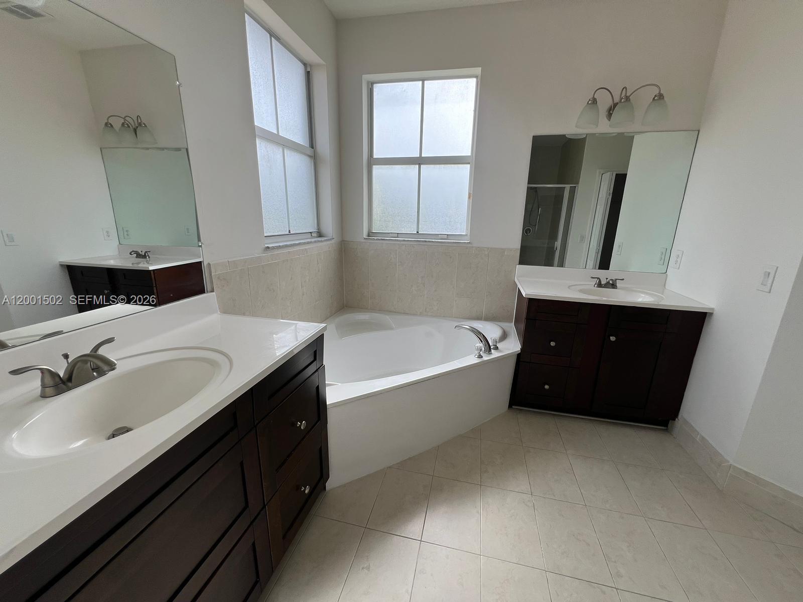 16568 Southwest 54th Street Miami, FL 33185 - Photo 12 of 30 a bathroom with a tub sink and mirror