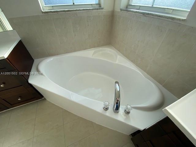 16568 Southwest 54th Street Miami, FL 33185 - Photo 14 of 30 a white bath tub sitting in a bathroom