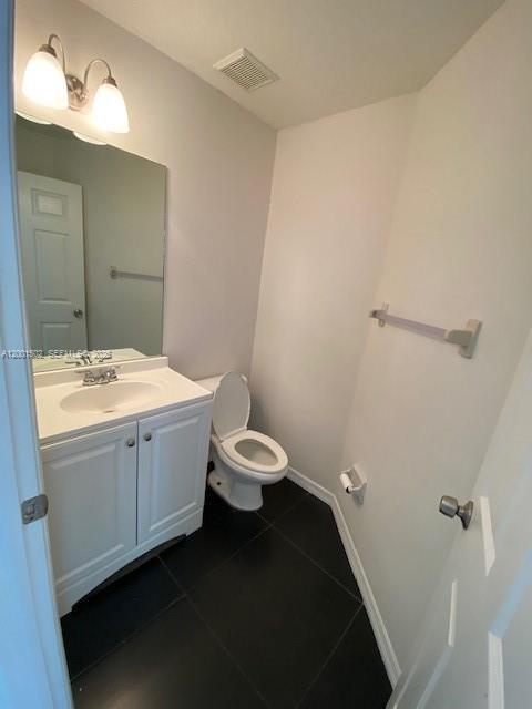 16568 Southwest 54th Street Miami, FL 33185 - Photo 21 of 30 a bathroom with a double vanity sink toilet and a mirror