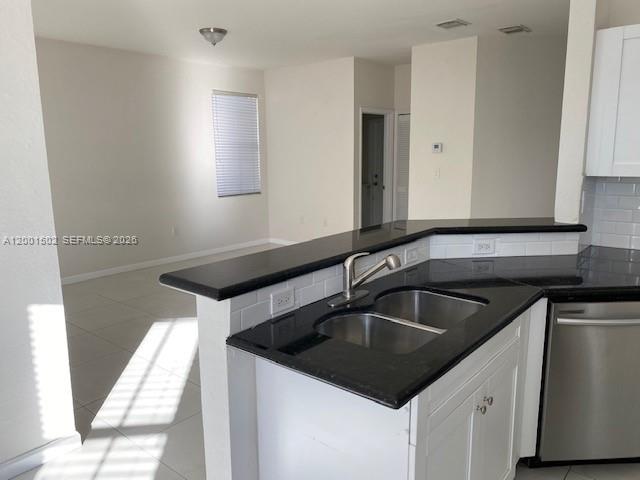 16568 Southwest 54th Street Miami, FL 33185 - Photo 5 of 30 a kitchen that has a sink and a stove