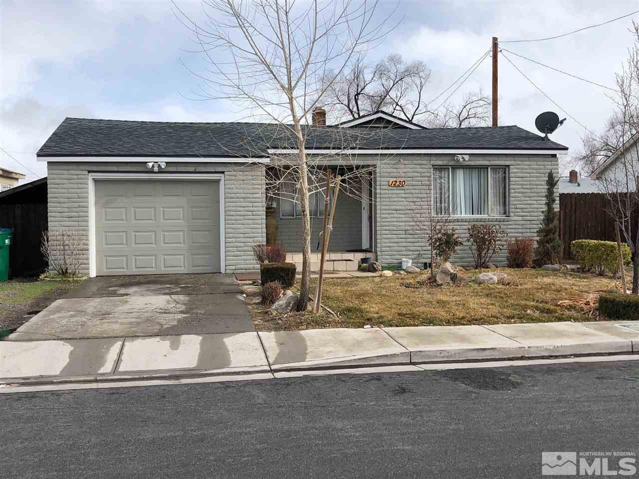 1230 Wilkinson Avenue Reno, NV 89502 - Photo 1 of 12 a front view of a house with garage