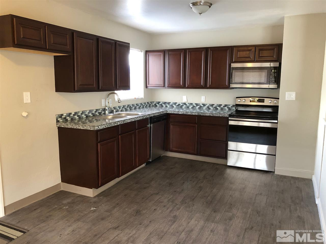 1230 Wilkinson Avenue Reno, NV 89502 - Photo 3 of 12 a kitchen with stainless steel appliances granite countertop wooden cabinets and a stove top oven