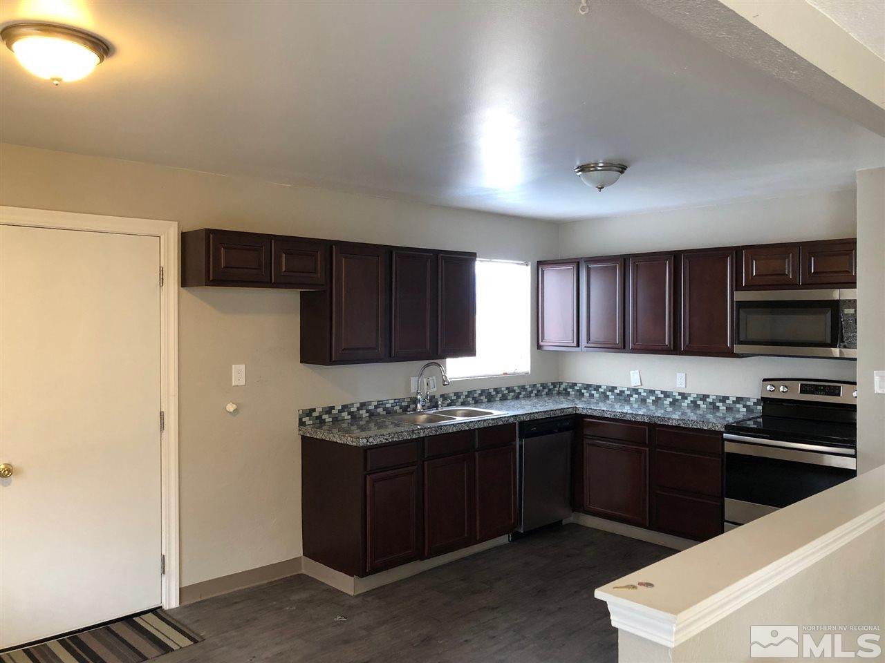 1230 Wilkinson Avenue Reno, NV 89502 - Photo 4 of 12 a kitchen with stainless steel appliances a sink and a stove