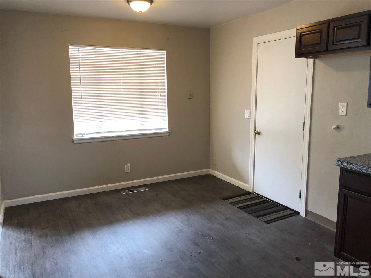 1230 Wilkinson Avenue Reno, NV 89502 - Photo 5 of 12 an empty room with wooden floor and windows