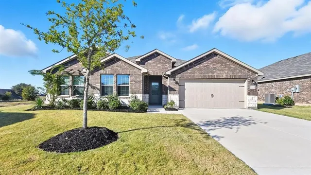 a view of a sign board with buildings in the background
