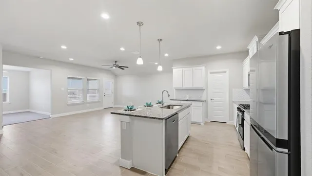 a front view of a house with a garden and yard