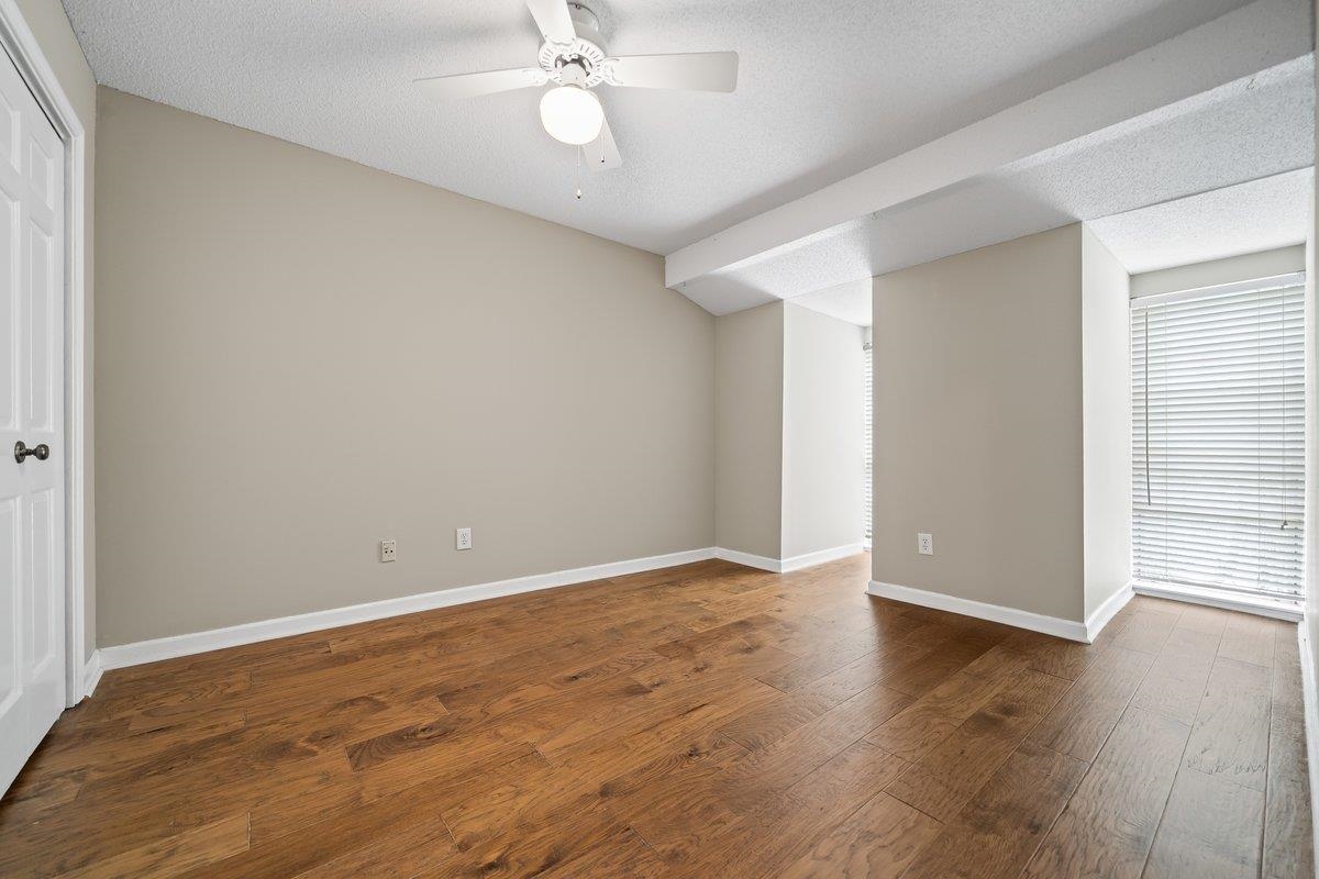6942 Amberly Road, Unit 6942 Memphis, TN 38119 - Photo 16 of 23 an empty room with wooden floor and windows
