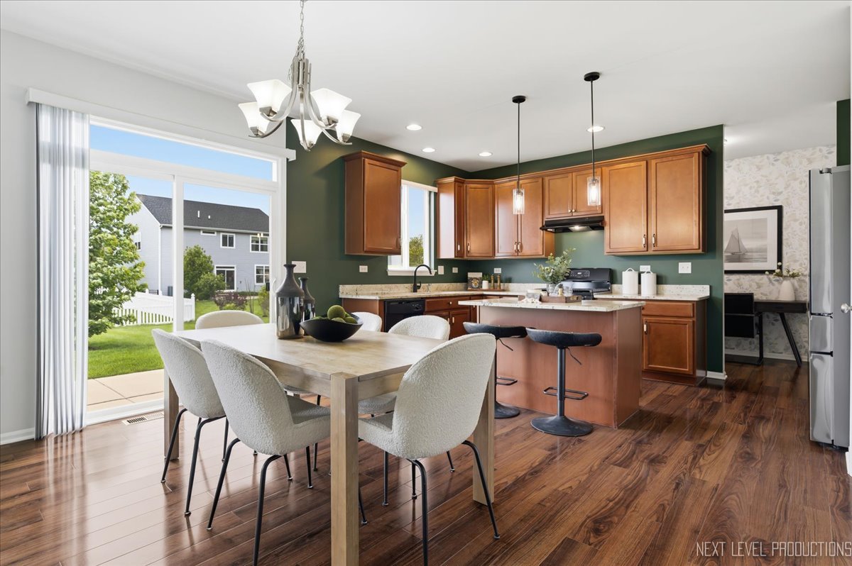 5734 Oak Ridge Way Lisle, IL 60532 - Photo 13 of 33 a view of a dining room with furniture window and wooden floor