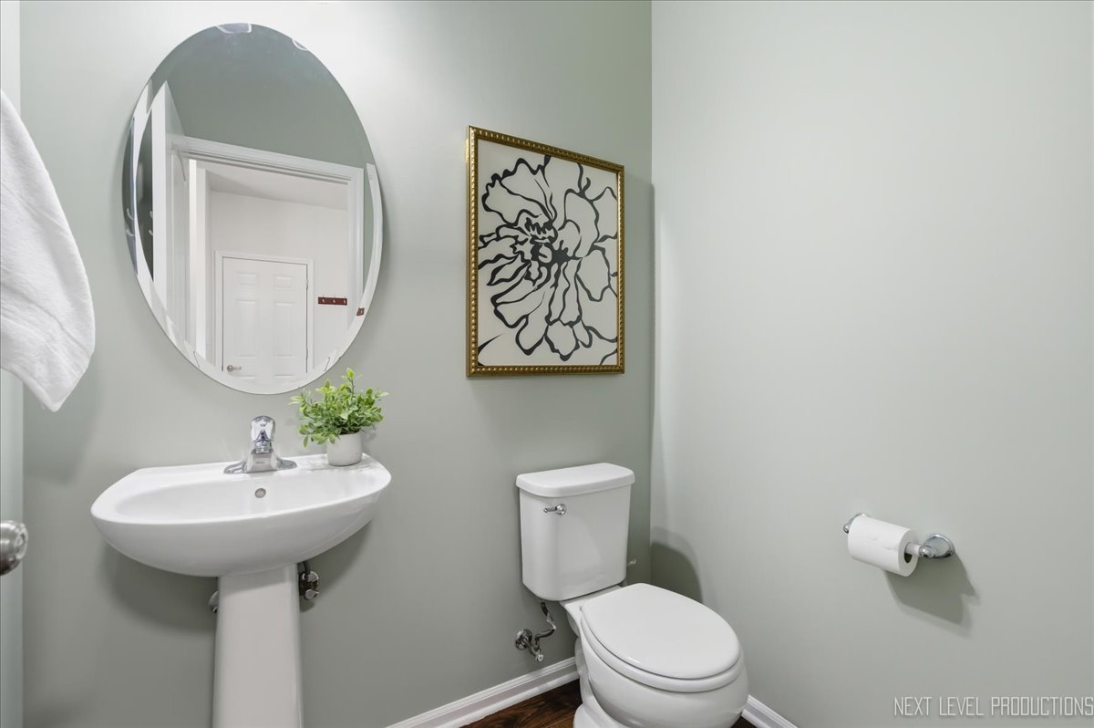 5734 Oak Ridge Way Lisle, IL 60532 - Photo 20 of 33 a bathroom with a toilet sink and mirror