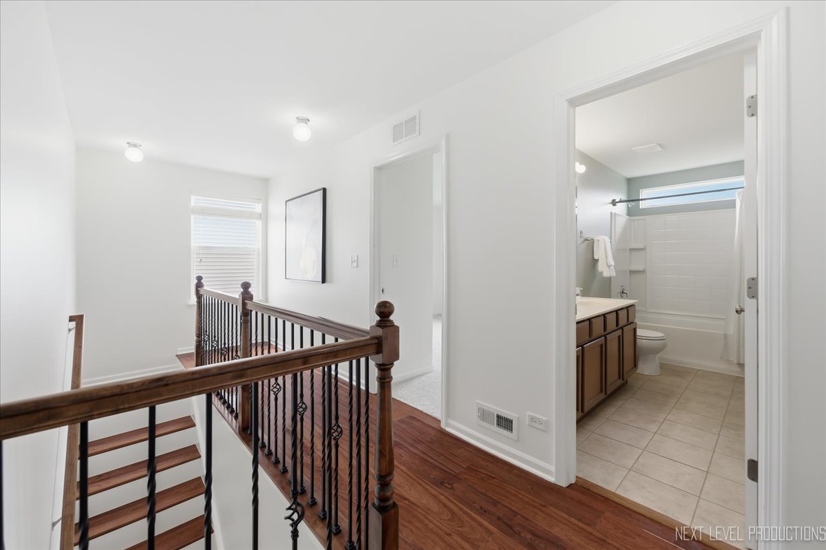 5734 Oak Ridge Way Lisle, IL 60532 - Photo 21 of 33 a view of hallway with stairs