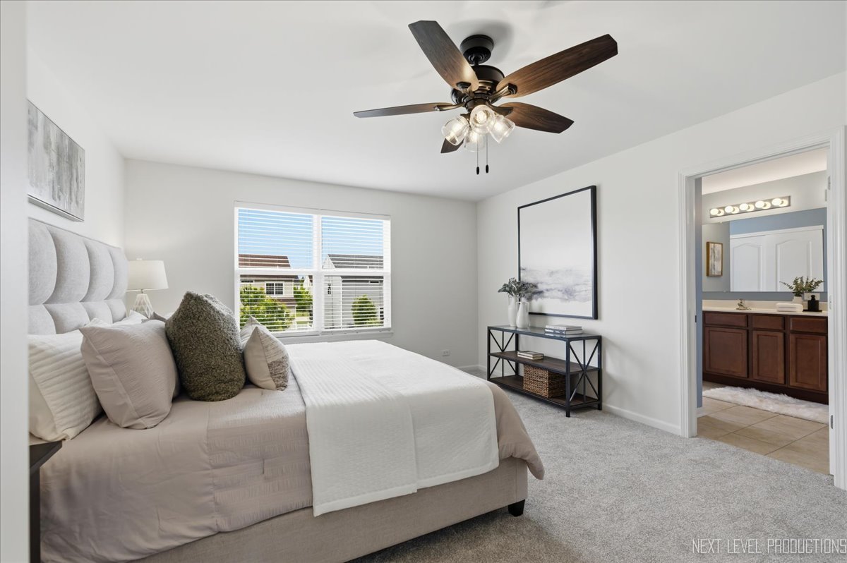 5734 Oak Ridge Way Lisle, IL 60532 - Photo 22 of 33 a bedroom with a large bed and a chandelier