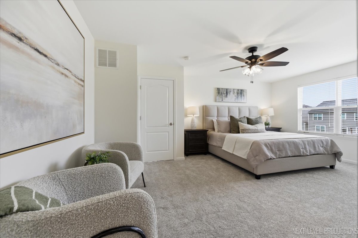 5734 Oak Ridge Way Lisle, IL 60532 - Photo 24 of 33 a bedroom with bed couch and window