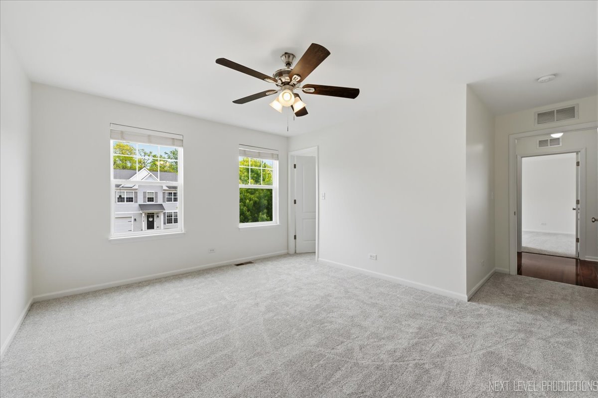 5734 Oak Ridge Way Lisle, IL 60532 - Photo 27 of 33 an empty room with windows and fan